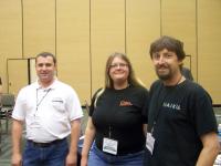 Urias, Leslie Hawthorn and Scott posing in front of the Haiku table.